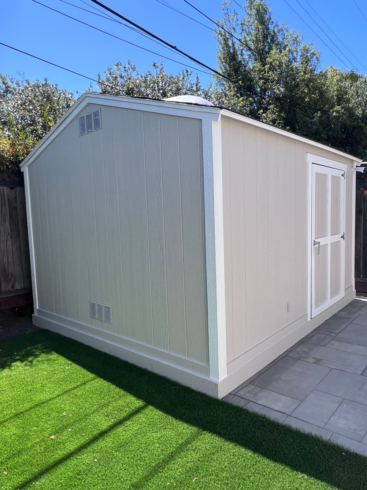 Home exterior after siding and trim replacement with fresh paint — bright white finish with crisp lines